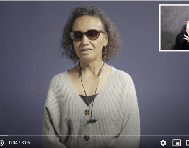 a snapshot of the video with a blind woman speaking and a certified deaf interpreter at the top right.